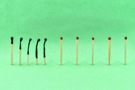 Selective focus. Ð¡losely located matchsticks burnt, when safe distancing between matchsticks...