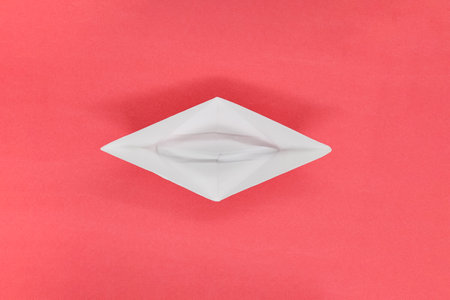 Paper boat as a symbol of business standing at the beginning of business developmentの写真素材