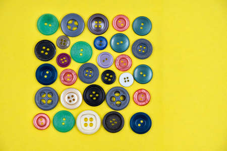 A variety of buttons on a yellow backgroundの写真素材