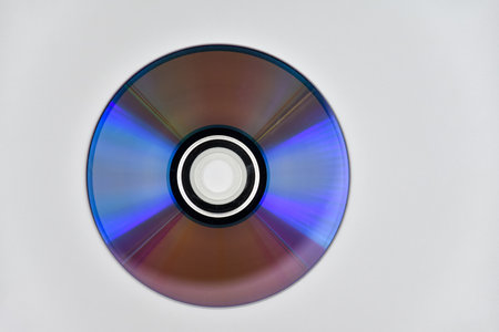 Used laser CD or DVD on the surface of the white backgroundの写真素材