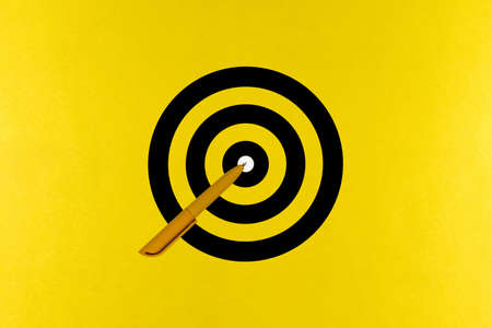 Yellow pen tip aimed precisely at the goal, the achievement of goals on yellow paper backroundの写真素材