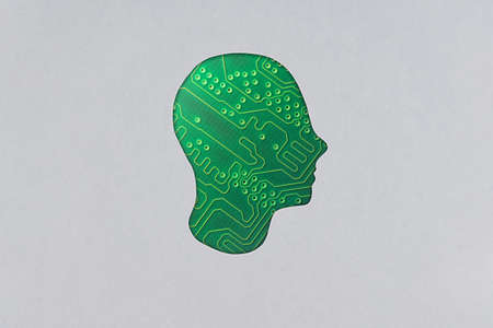 Silhouette of a human cardboard head cutout containing electronic components, revealing circuit boardの写真素材