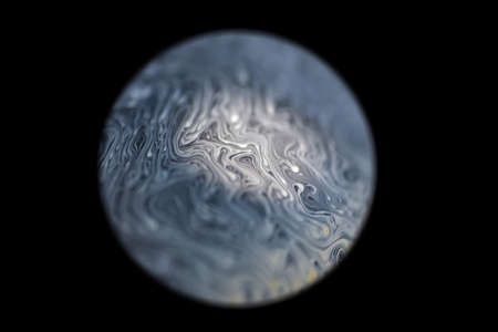 Gray colored cold alien planet, spotlighted by the sun with an atmosphere in universe on dark background. Soap bobbleの写真素材