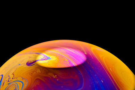 Soap bobble close-up. Multicolor psychedelic alien planet with an atmosphere in the darkness of the...