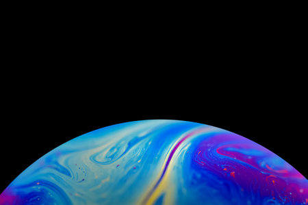Soap bobble close-up. Multicolor psychedelic alien planet with an atmosphere in the darkness of the...