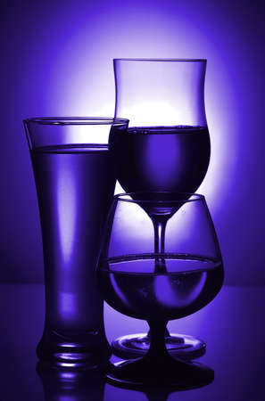 Silhouettes of glasses in blue. Toning.     の写真素材