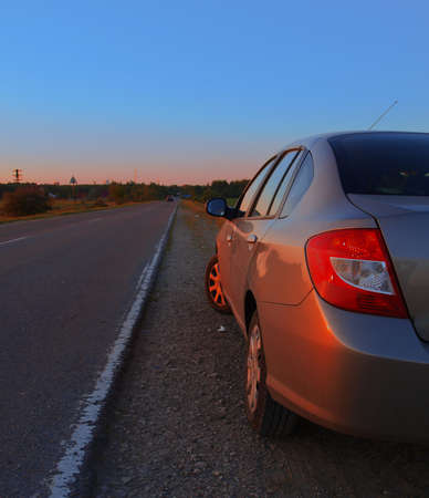 Vehicle is on the side of the highway evening    の写真素材
