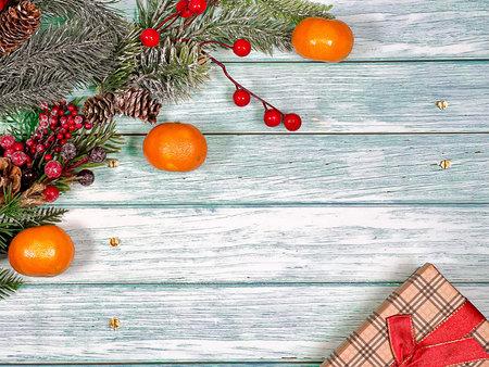 Christmas festive background of pine branches, gifts and toys on vintage boards. The concept of a...