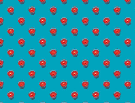 Seamless pattern of red candles on a blue background. Christmas or Valentine background.