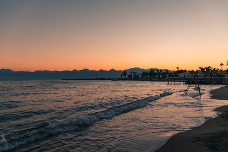 Bright, beautiful sunset on the sea with mountain views. The concept of natural beauty.の写真素材