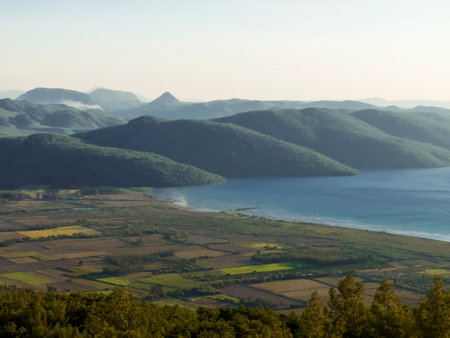 Beautiful landscape with sea mountains and rural fields. The concept of the beauty of nature.の写真素材