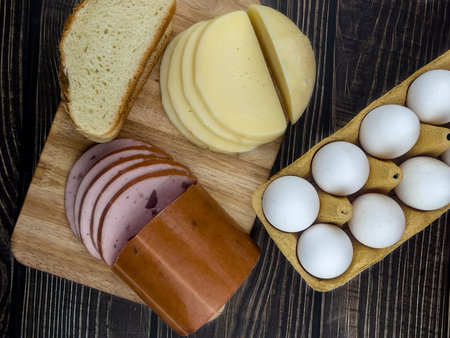 Sliced gastronomic products on a wooden table in close-up. The concept of home gastronomy.の写真素材
