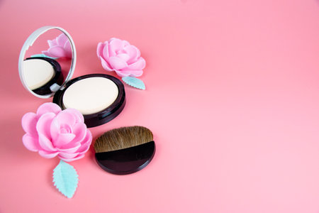 Still life with decorative cosmetics and pink flowers.The concept of women's beauty and fashion.の写真素材