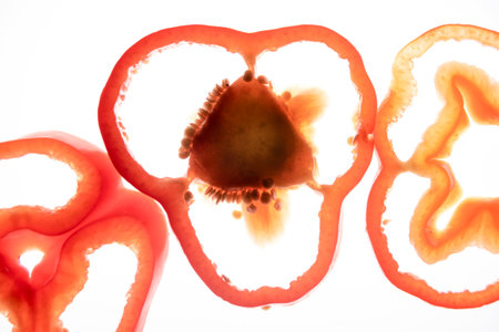 Slices of sliced red sweet pepper removed to the lumen. The concept of healthy and healthy vegetables.の写真素材