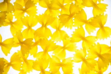Pasta in the form of bows on a white background on the lumen. The concept of healthy food.の写真素材