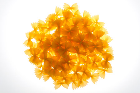 A pile of raw pasta on a white background. close-up shooting.の写真素材