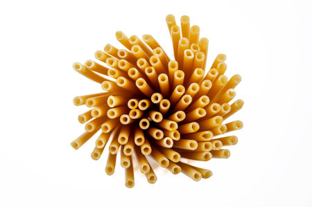 A bunch of raw spaghetti on a white background. Close-up shooting from above.の写真素材