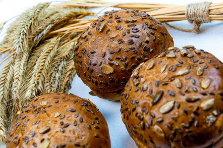 Buns with seeds with bread ears on a white background. bakery concept.