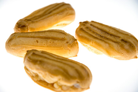 Mini eclairs on a white background. The concept of pleasant sweets.
