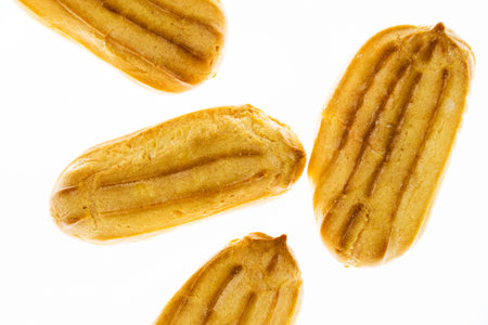 Mini eclairs on a white background. The concept of pleasant sweets.