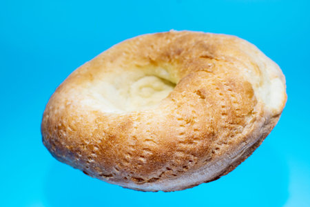 Uzbek flatbread on a blue background in levitation. National Uzbek cuisine.の写真素材