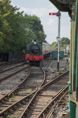 0.6.0 tank loco pulling coaches on a sunny day