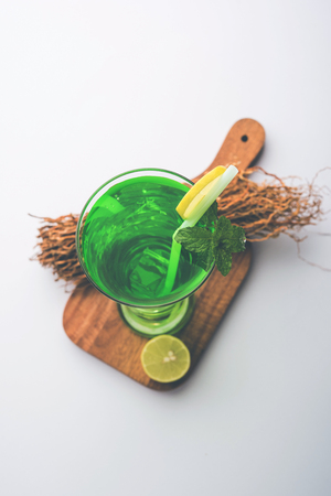 Khus Sharbat or Vetiver Drink served in a glass with Mint and Lemon slice, selective focusの写真素材