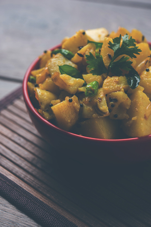 Chatpate Masala Aloo Sabzi fry OR Bombay potatoes served in a bowl, selective focusの写真素材