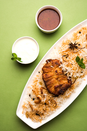 Authentic Fish Biryani served in a white plate over white background, selective focusの写真素材