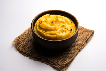Amrakhand OR Mango Shrikhand / srikhand is popular Indian dessert served with saffron toppings in a bowlの写真素材