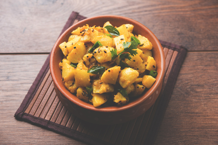Chatpate Masala Aloo Sabzi fry OR Bombay potatoes served in a bowl, selective focusの写真素材