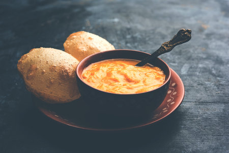 Aam Ras Puri OR Alphonso  Mango pulp with fried Poori, selective focus