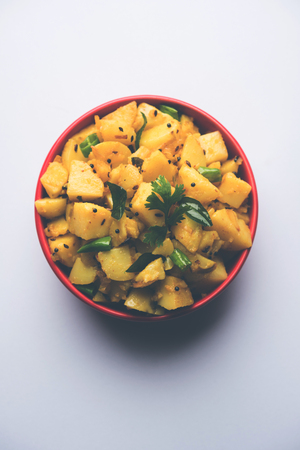 Chatpate Masala Aloo Sabzi fry OR Bombay potatoes served in a bowl, selective focusの写真素材