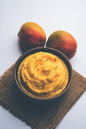 Amrakhand OR Mango Shrikhand / srikhand is popular Indian dessert served with saffron toppings in a bowlの写真素材