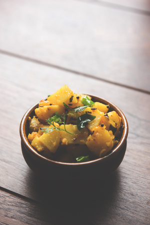 Chatpate Masala Aloo Sabzi fry OR Bombay potatoes served in a bowl, selective focusの写真素材
