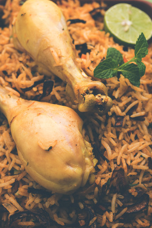 Indian Chicken Biryani served in a terracotta bowl with yogurt over white background. selective focusの写真素材