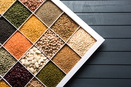 Indian Beans,Pulses,Lentils,Rice and Wheat grain in a white wooden box with cells, selective focus.の写真素材