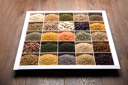 Indian Beans,Pulses,Lentils,Rice and Wheat grain in a white wooden box with cells, selective focus.の写真素材
