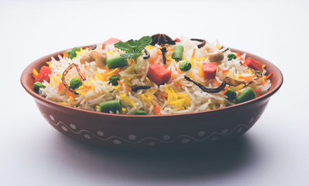Indian Vegetable Pulav or Biryani made using Basmati Rice, served in a ceramic bowl. selective focusの写真素材