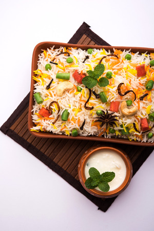 Indian Vegetable Pulav or Biryani made using Basmati Rice, served in a ceramic bowl. selective focusの写真素材