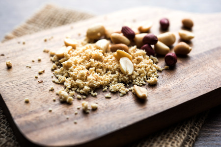 Crushed peanuts or mungfali powder with whole and roasted groundnut. Served in a bowl over moody background. Selective focusの写真素材