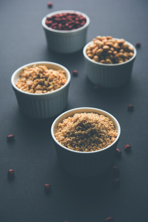Crushed peanuts or mungfali powder with whole and roasted groundnut. Served in a bowl over moody background. Selective focusの写真素材