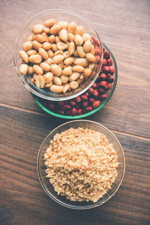 Crushed peanuts or mungfali powder with whole and roasted groundnut. Served in a bowl over moody background. Selective focusの写真素材