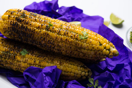 Delicious Indian street corn cob also called Bhutta, flavoured with spicy chilli, butter etc....