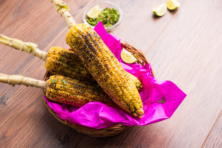 Delicious Indian street corn cob also called Bhutta, flavoured with spicy chilli, butter etc....