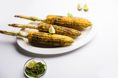 Delicious Indian street corn cob also called Bhutta, flavoured with spicy chilli, butter etc. Selective focusの写真素材