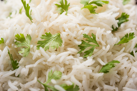 Coriander or cilantro Basmati Rice, served in a ceramic or terracotta bowl. It's a popular Indian OR Chinese recipe. Selective focusの写真素材