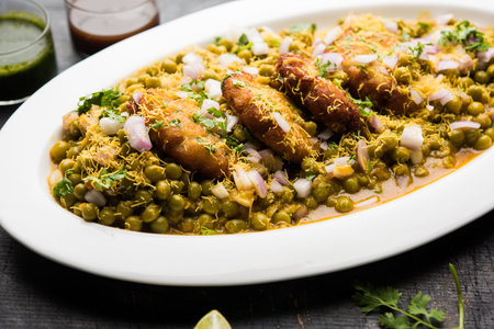 Ragda Pattice is a popular Street food or chat made of potato Patties. served in a steel plate, bowl...