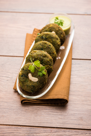 Hara bhara Kabab or Kebab is Indian vegetarian snack recipe served with green mint chutney over moody background. selective focusの写真素材
