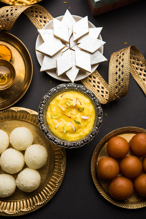 Raksha bandhan greetings : Sweet food like Gulab Jamun, Rasgulla, Shrikhand, Bundi Laddu, Kaju Katli and farsan with Pooja thali for Rakhi Festival Celebrationの写真素材